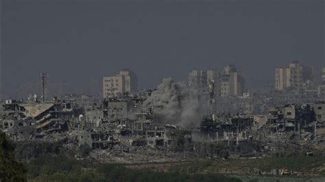 Airstrikes level apartment blocks in Gaza refugee camp